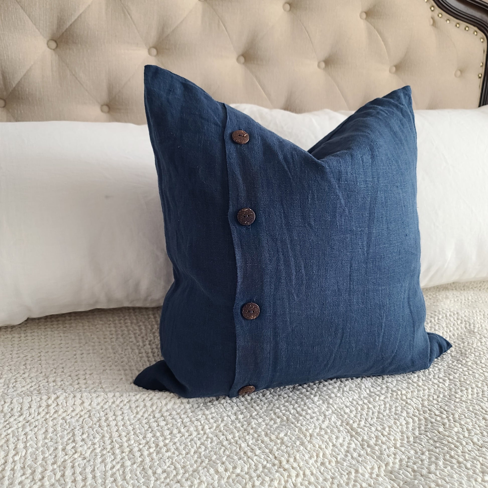 Blue linen pillow  on the white bed